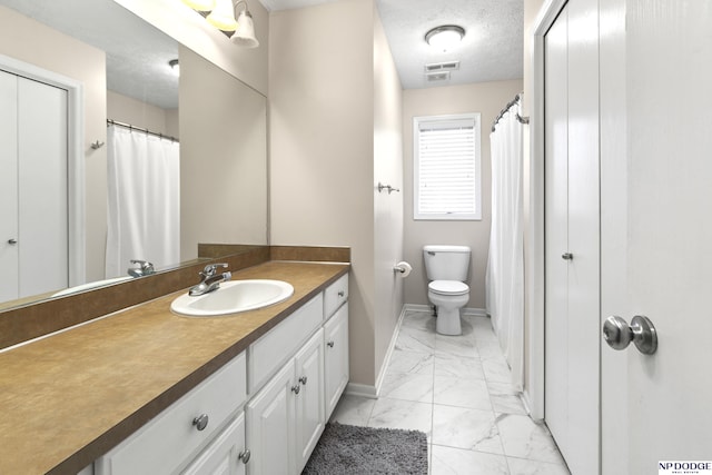 bathroom featuring visible vents, toilet, vanity, marble finish floor, and a textured ceiling