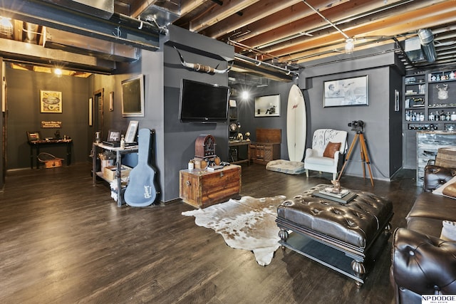 living area with arched walkways and wood finished floors