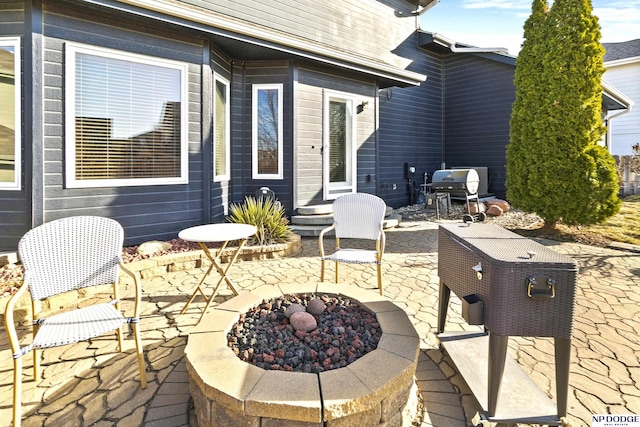 view of patio featuring grilling area and a fire pit