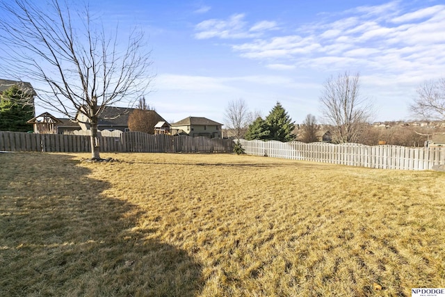 view of yard with a fenced backyard