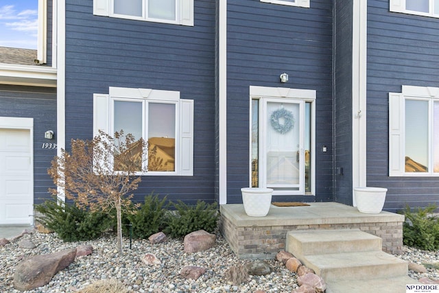 view of exterior entry featuring a garage