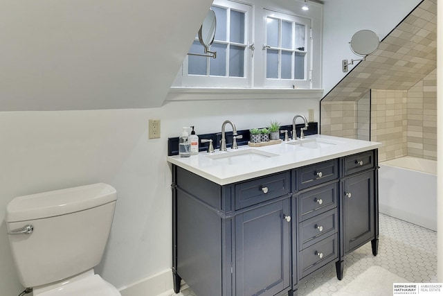 bathroom featuring double vanity, a washtub, toilet, and a sink