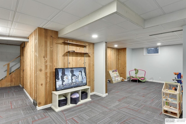 rec room with baseboards, wood walls, and carpet flooring