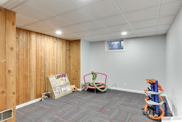 game room featuring visible vents, wood walls, baseboards, and carpet