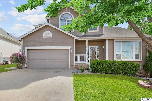 traditional-style house with a garage, driveway, a front yard, and roof with shingles