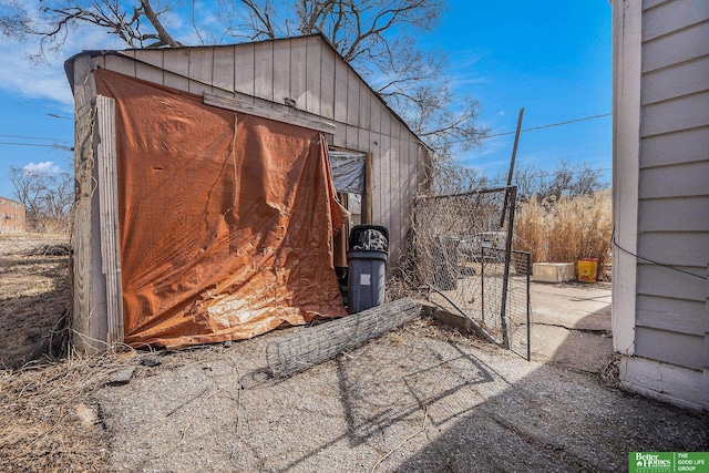 view of outbuilding with an outdoor structure and a gate