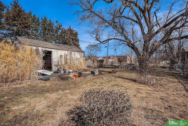 view of yard featuring an outdoor structure and fence