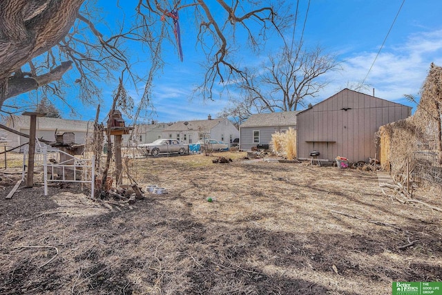 view of yard with an outdoor structure and fence