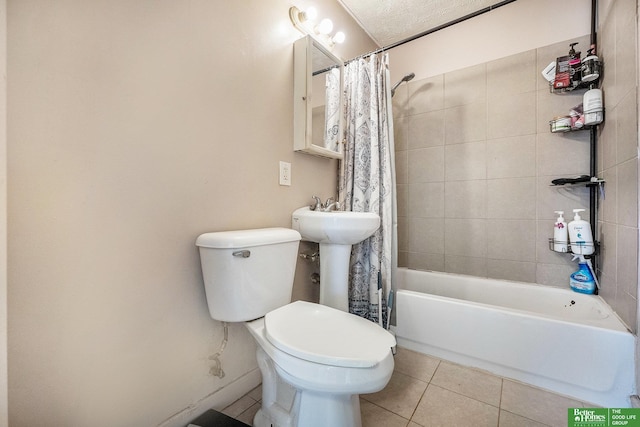 full bath with tile patterned floors, shower / bath combination with curtain, toilet, and baseboards