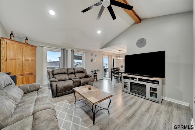 living area featuring a ceiling fan, baseboards, lofted ceiling with beams, recessed lighting, and light wood-style floors