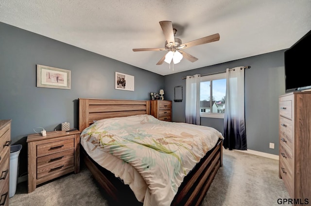 bedroom featuring a textured ceiling, carpet flooring, baseboards, and ceiling fan