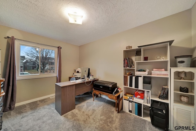 home office featuring baseboards, carpet floors, and a textured ceiling