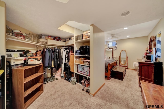 spacious closet featuring a ceiling fan and carpet floors