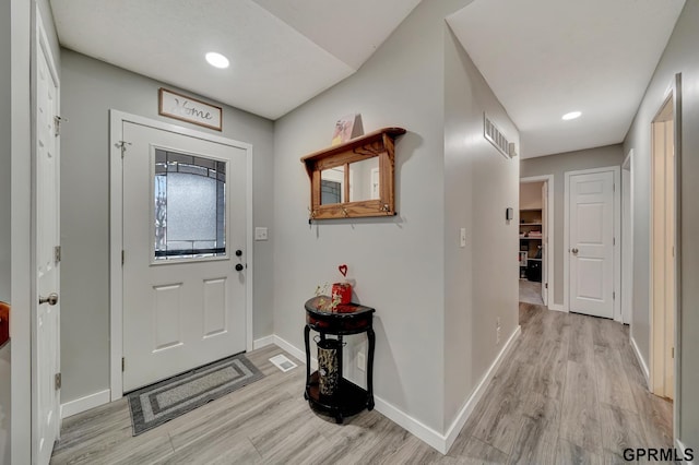 foyer featuring recessed lighting, visible vents, light wood-style flooring, and baseboards