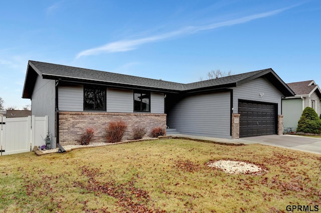 view of front of house with a gate, fence, concrete driveway, a garage, and brick siding