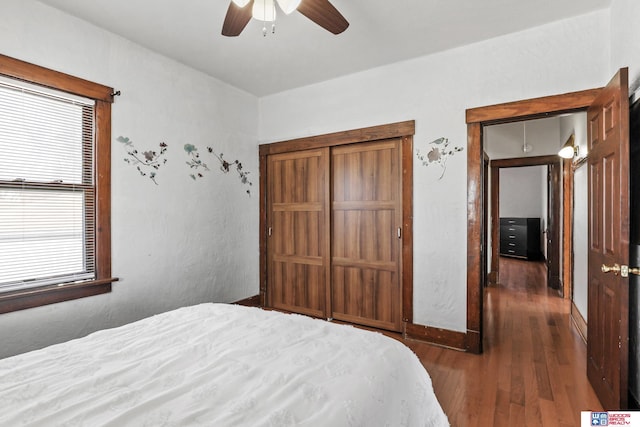 bedroom with baseboards, wood finished floors, and a ceiling fan