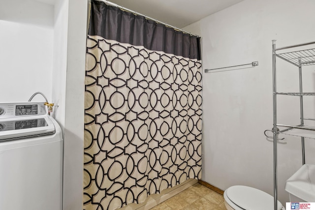 full bath featuring toilet, curtained shower, and washer / clothes dryer