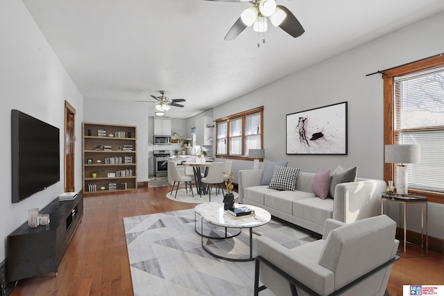 living room with wood finished floors and ceiling fan