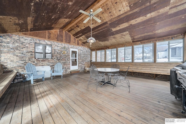 wooden deck featuring outdoor dining area and a ceiling fan