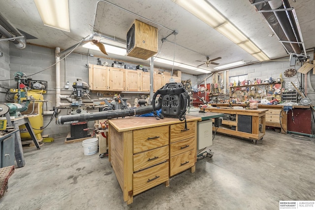 interior space featuring a workshop area and concrete block wall