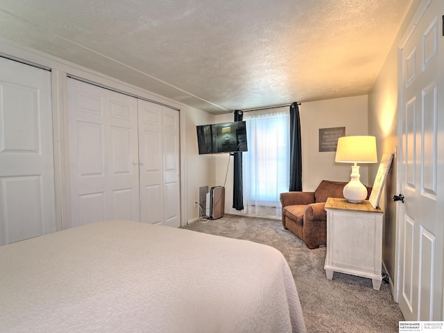 carpeted bedroom featuring a closet and a textured ceiling