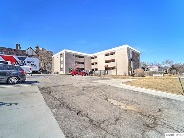 view of property featuring uncovered parking