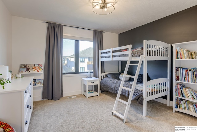 bedroom featuring light colored carpet and visible vents