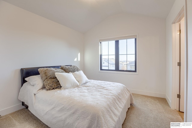 bedroom with lofted ceiling, baseboards, and carpet floors