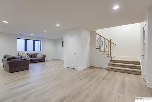 living room featuring stairway, visible vents, baseboards, light wood finished floors, and recessed lighting