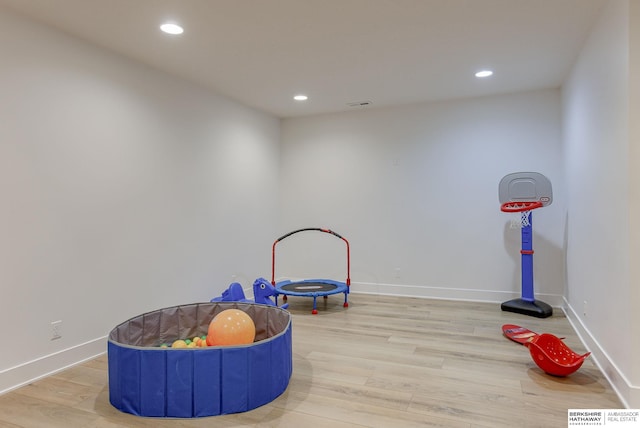 rec room with recessed lighting, visible vents, baseboards, and wood finished floors