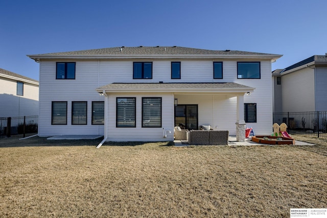 back of property featuring a yard, an outdoor hangout area, a patio, and fence