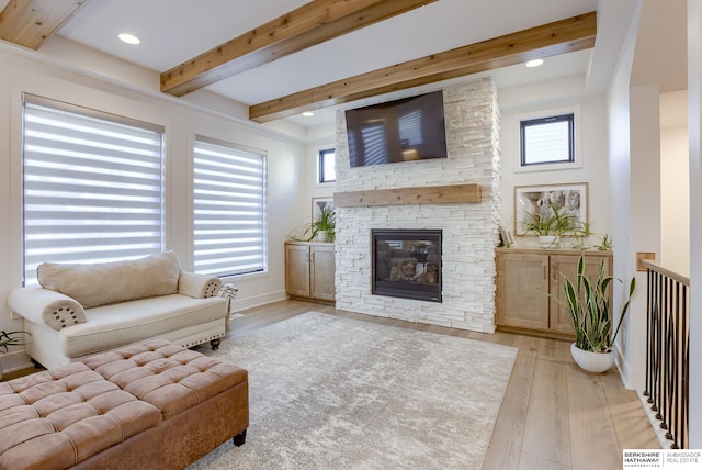 living room with wood finished floors, baseboards, beam ceiling, a fireplace, and recessed lighting