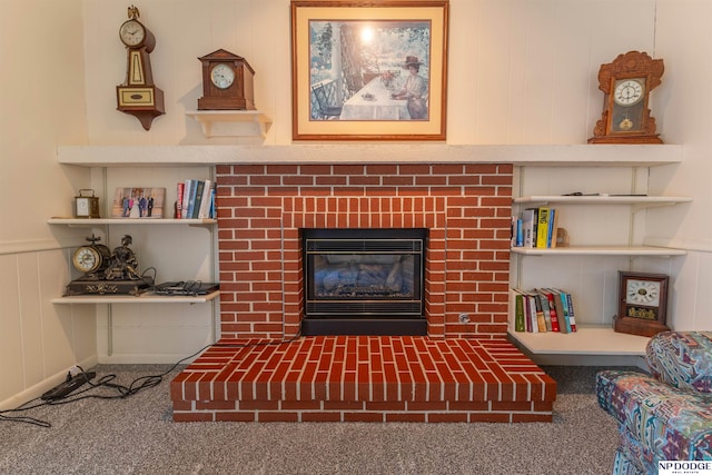 living room featuring a brick fireplace and carpet