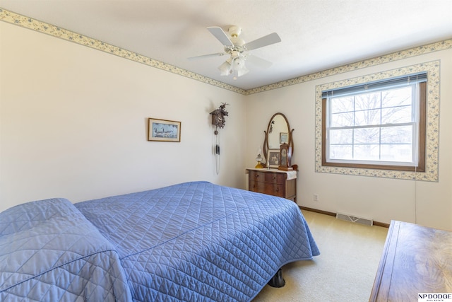 carpeted bedroom featuring baseboards, visible vents, and ceiling fan