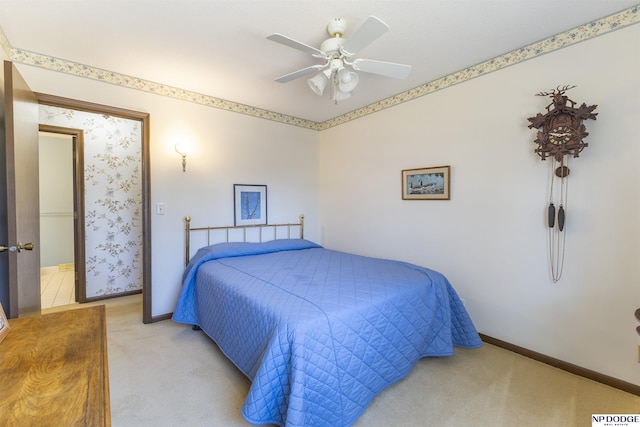 bedroom with light colored carpet, baseboards, and ceiling fan