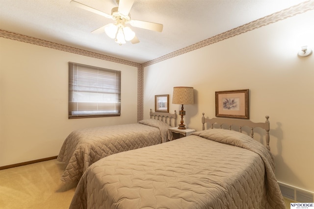 bedroom with visible vents, baseboards, carpet, and ceiling fan