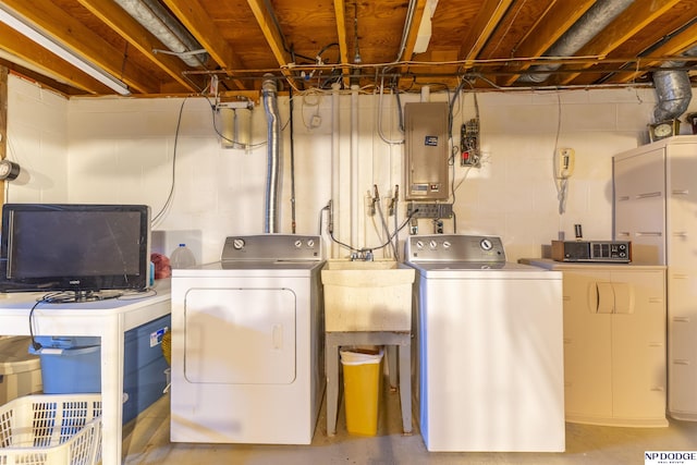 washroom with a sink, laundry area, electric panel, and washer and clothes dryer