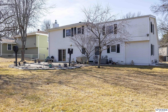 rear view of property with a patio, cooling unit, fence, a chimney, and a lawn