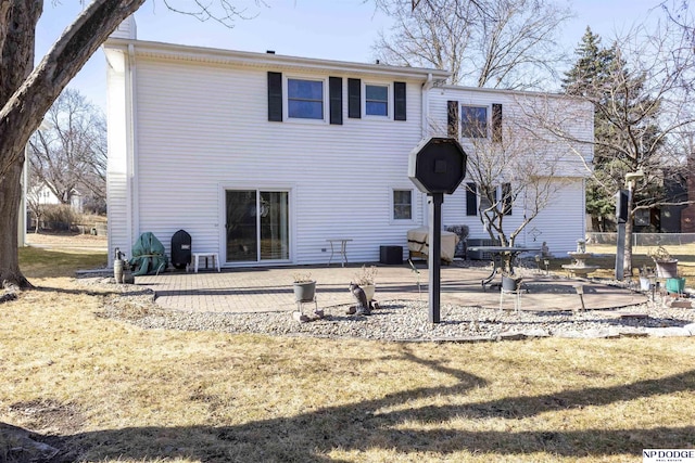 back of house with fence, a lawn, and a patio area