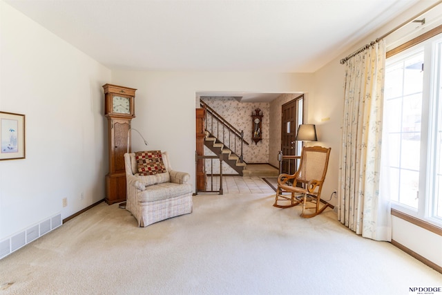 living area with stairs, carpet flooring, baseboards, and visible vents