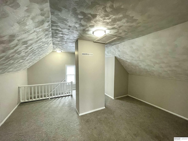 bonus room with visible vents, baseboards, and a textured ceiling