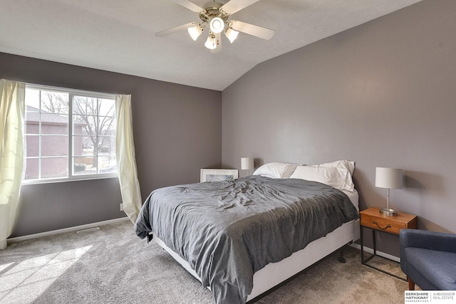 bedroom featuring baseboards, lofted ceiling, and carpet