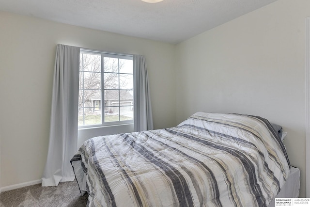 carpeted bedroom featuring baseboards