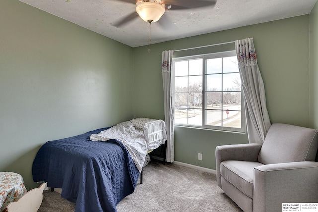 bedroom featuring a ceiling fan, baseboards, a textured ceiling, and carpet flooring