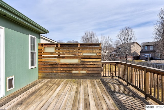 wooden terrace featuring fence and a residential view