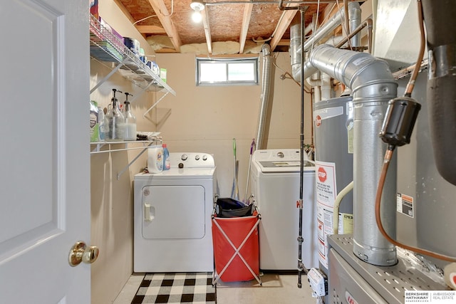 laundry area with light floors, independent washer and dryer, and water heater