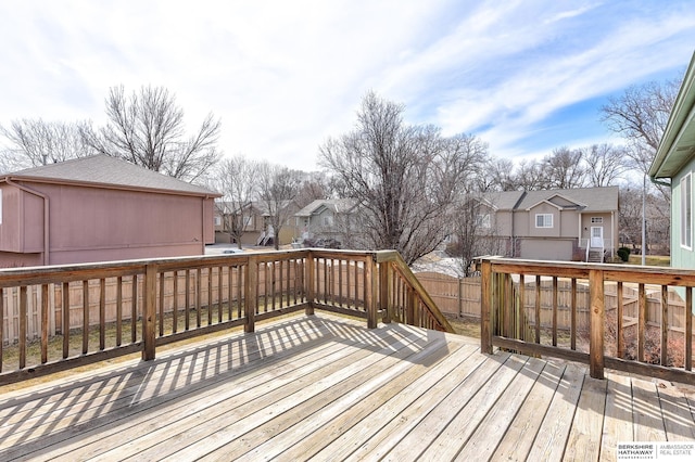 deck with a residential view and fence