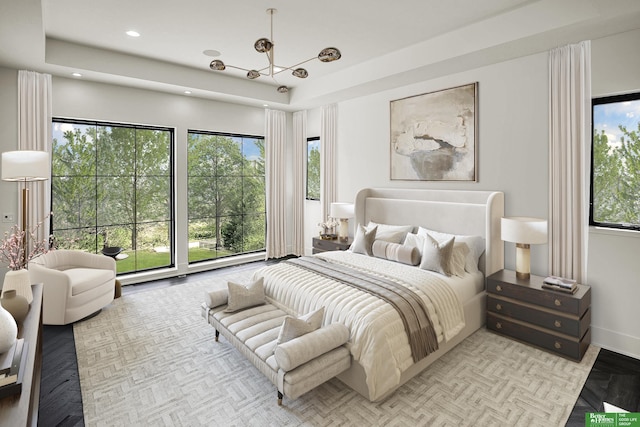 bedroom featuring recessed lighting, baseboards, and a tray ceiling