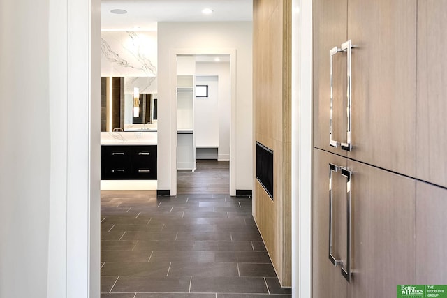 hallway with dark wood-style floors and baseboards