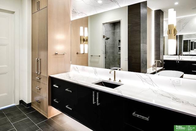 full bath featuring a tile shower, tile patterned floors, and vanity